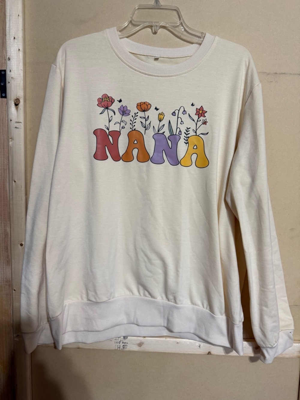 Cream Sweatshirt with Colorful "NANA" Floral Graphic